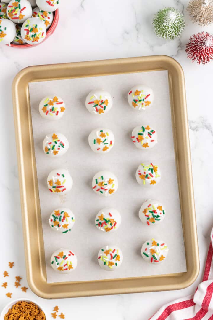 decorating the gingerbread truffles with Christmas sprinkles.