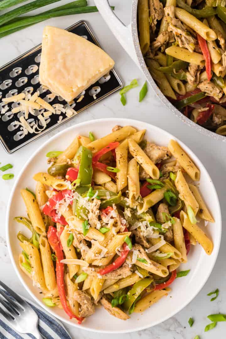 Rasta Pasta topped with shredded parmesan cheese.