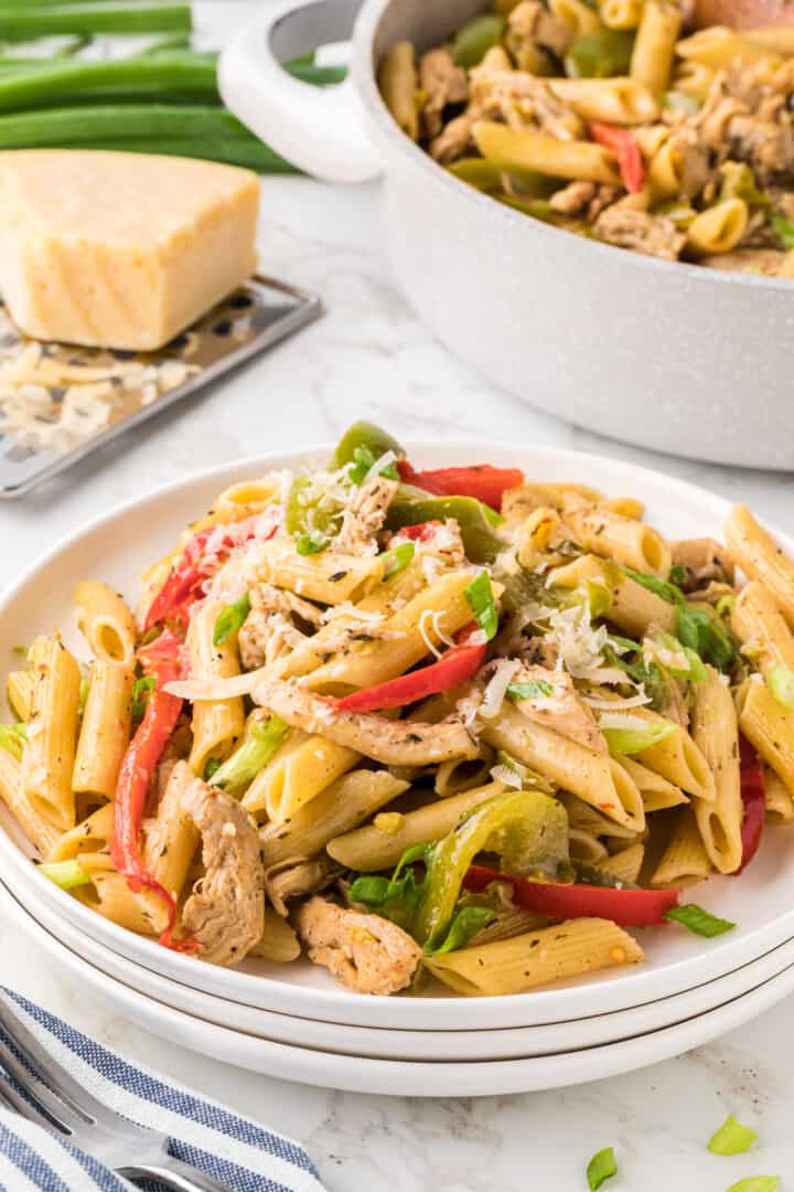 closeup of Rasta Pasta on 3 stacked white plates.