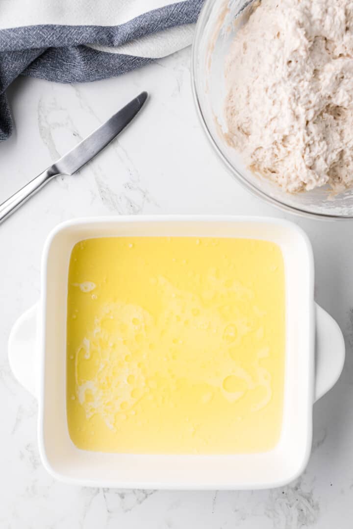 melted butter in the bottom of the baking dish.