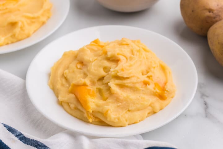 Cheesy Mashed Potatoes on white plate.