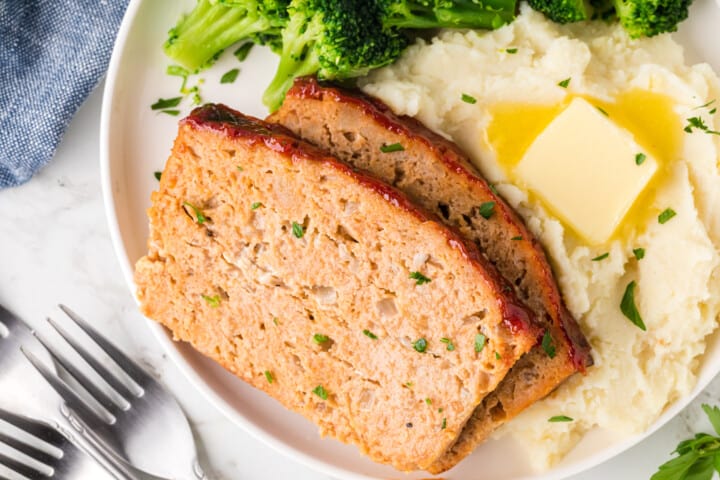 two slices of chicken meatloaf with mashed potatoes.