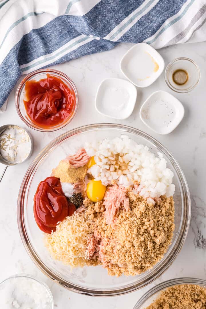 all meatloaf ingredients in large glass bowl.