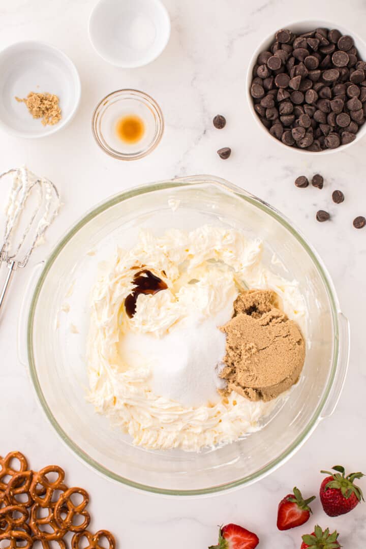 adding the sugars and vanilla to the cream cheese and sugar.