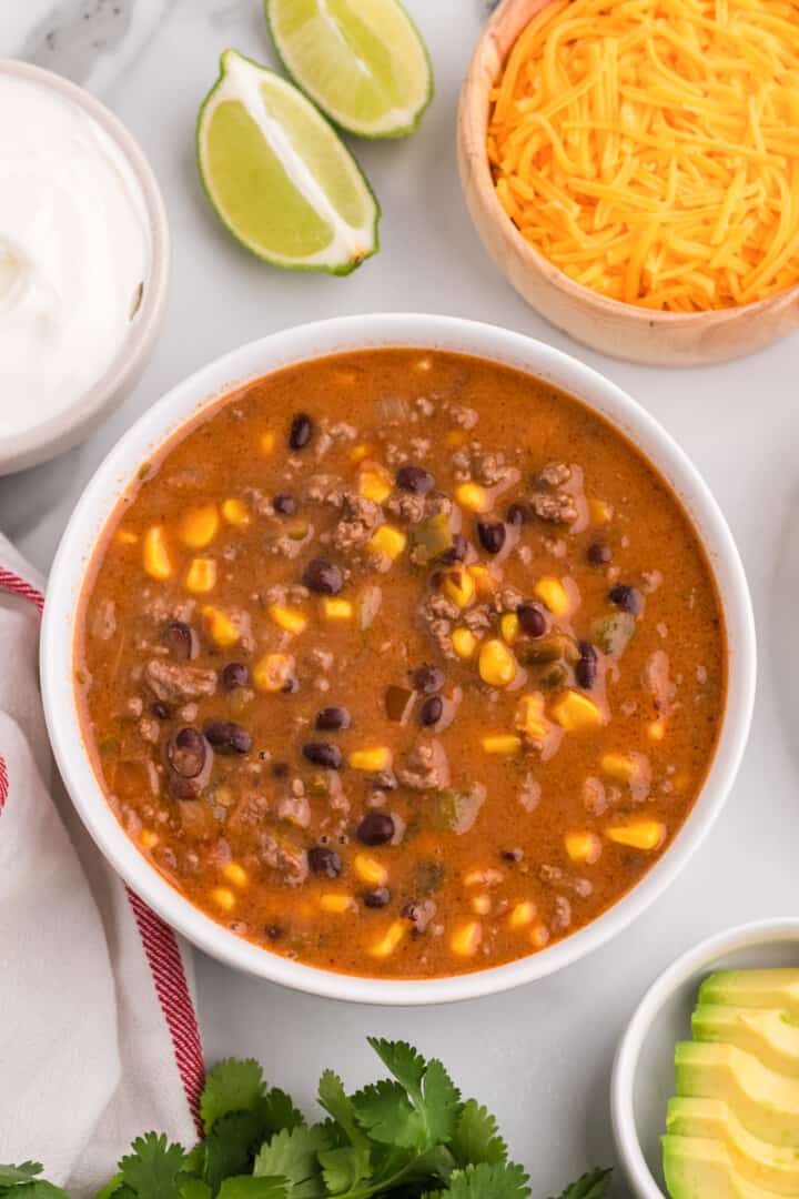 closeup of creamy taco soup in white bowl.