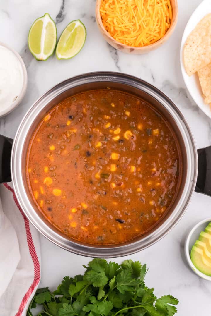 creamy taco soup cooking in large pot.