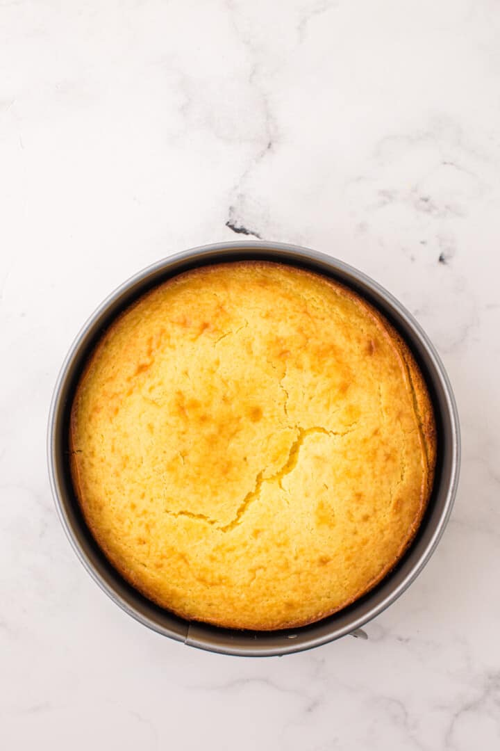 baked lemon ricotta cake in cake pan.