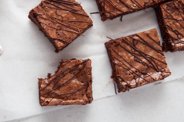 brownies sliced into squares, one with a bite taken out of it.