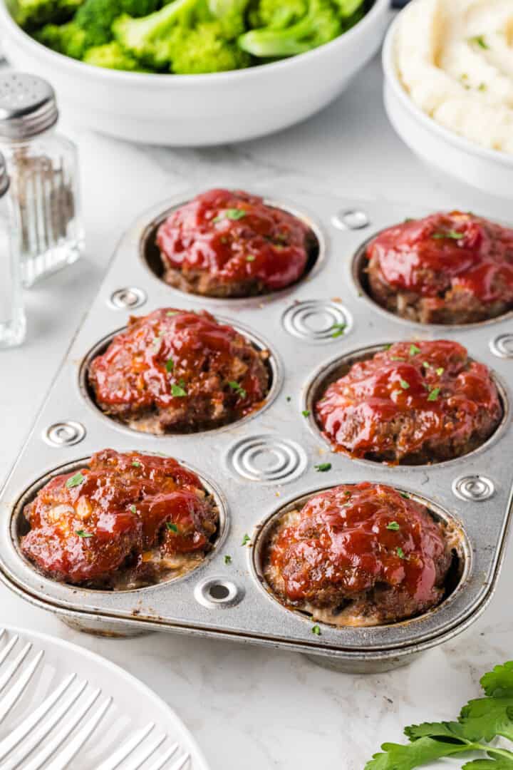 baked mini meatloaf in the pan still.