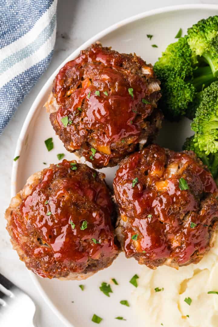 closeup of the mini meatloaves on dinner plate with sides.