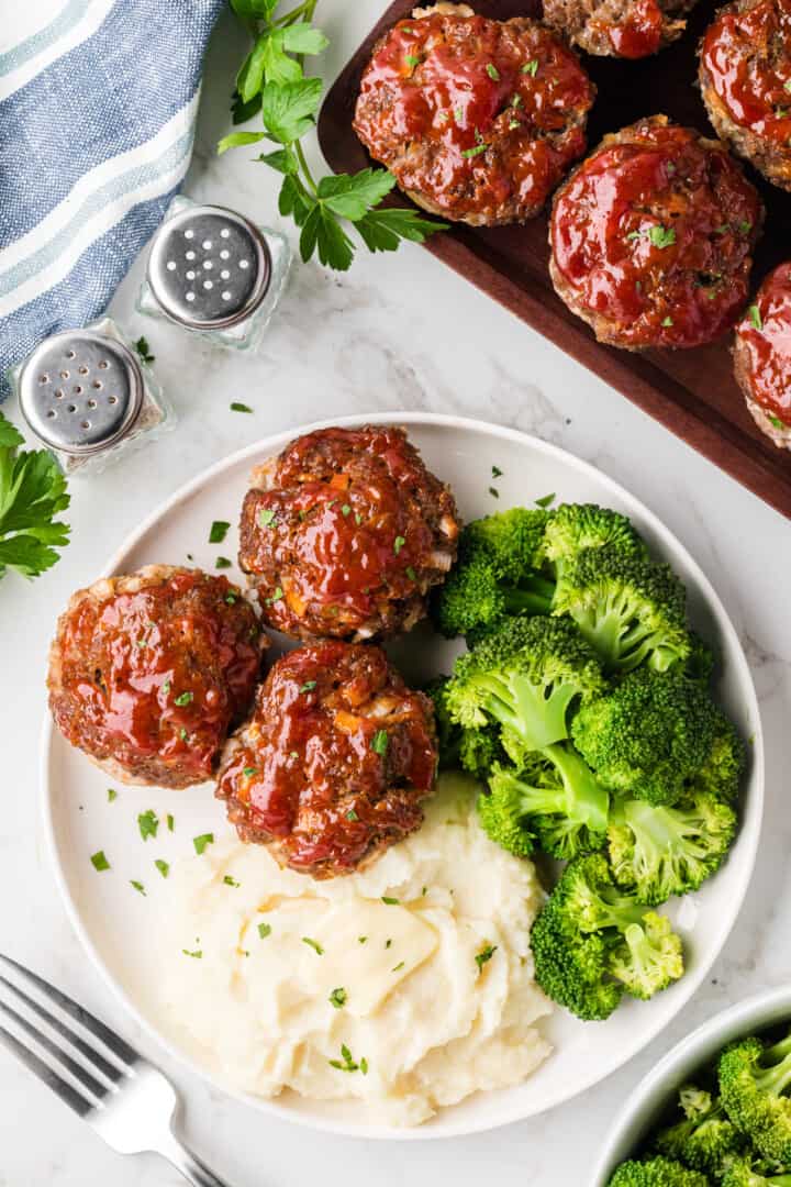 Mini Meatloaf on plate with mashed potatoes and broccoli. 