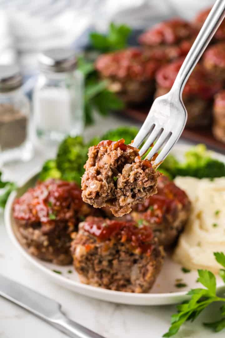 eating the mini meatloaf with a fork.