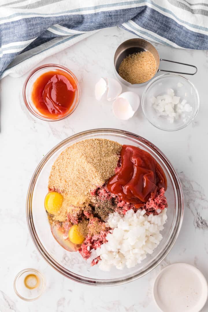 ingredients to make the mini meatloaf in glass bowl for mixing.