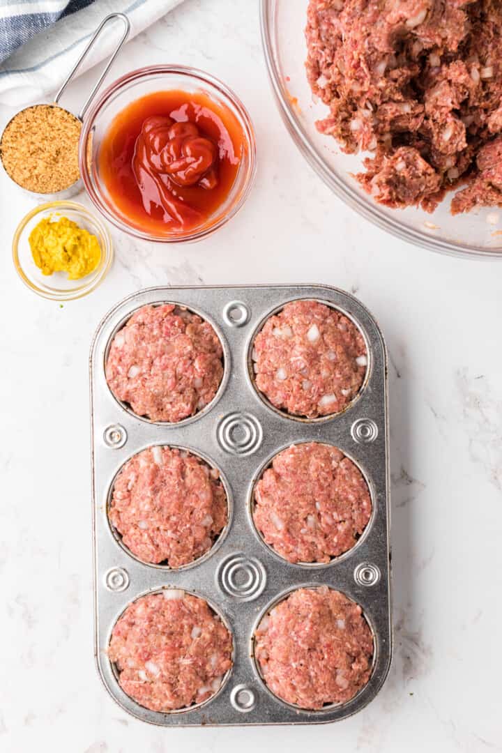 mini meatloaf in cupcake pan ready to bake.