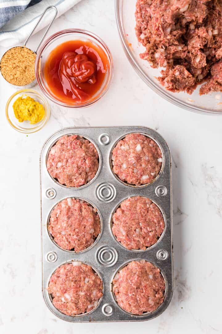 mini meatloaf in cupcake pan ready to bake.