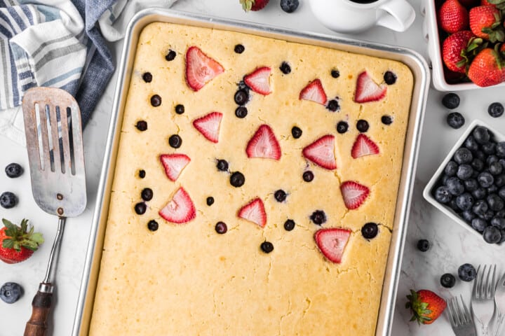 baked Sheet Pan Pancakes with fruit on one half.