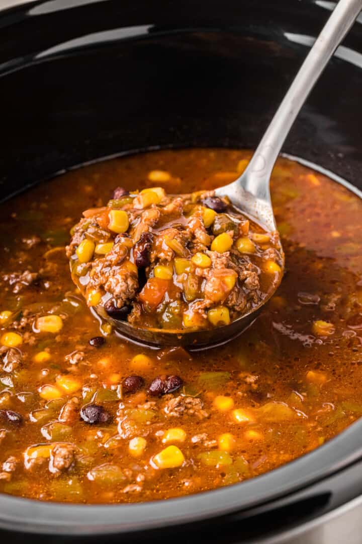 using a ladle to serve the soup.