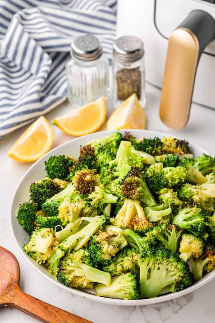 closeup of the air fryer broccoli in white serving bowl.