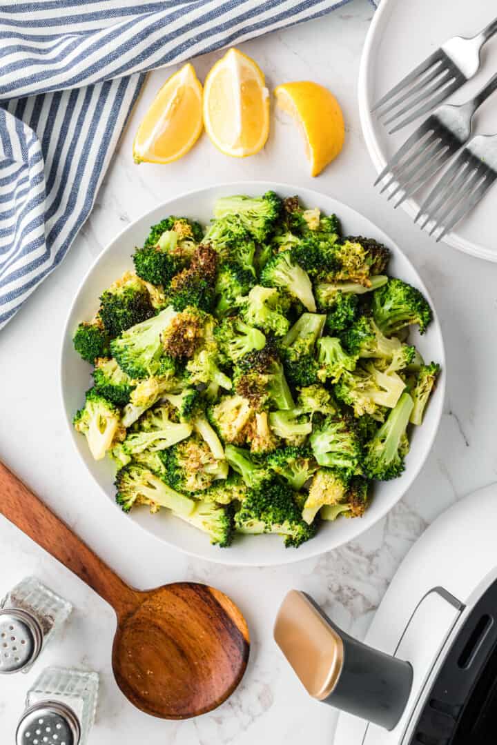 air fryer broccoli in a white serving bowl.