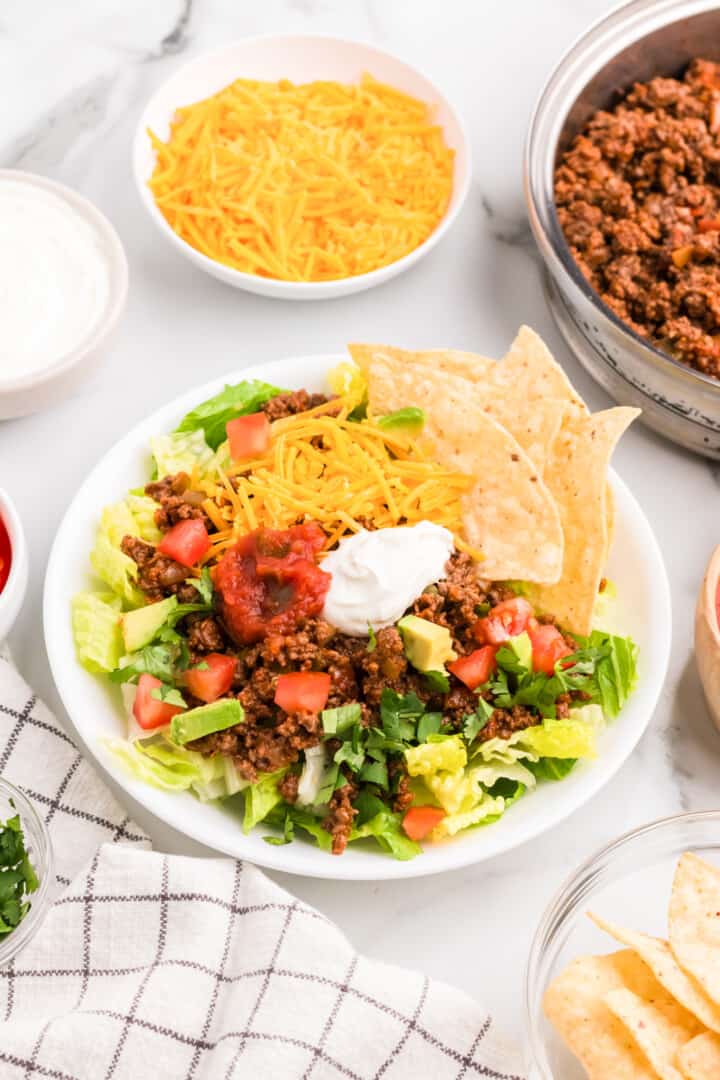 taco salad made in a white bowl.