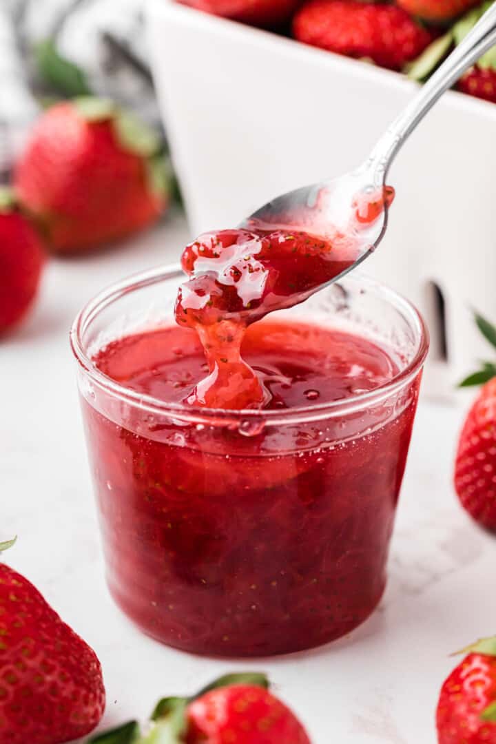 Strawberry Syrup in a glass cup for serving.