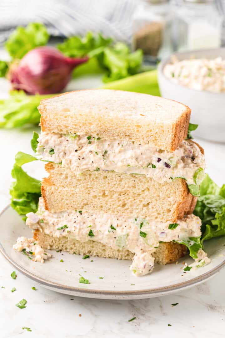 Tuna Salad sandwich stacked on a white serving plate.