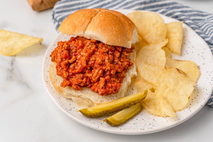 Turkey sloppy joes on a plate with chips.