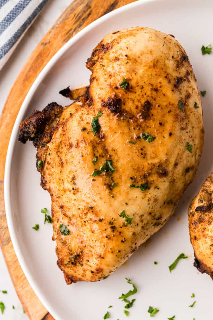 Air Fryer Chicken cooked and on a white dinner plate.