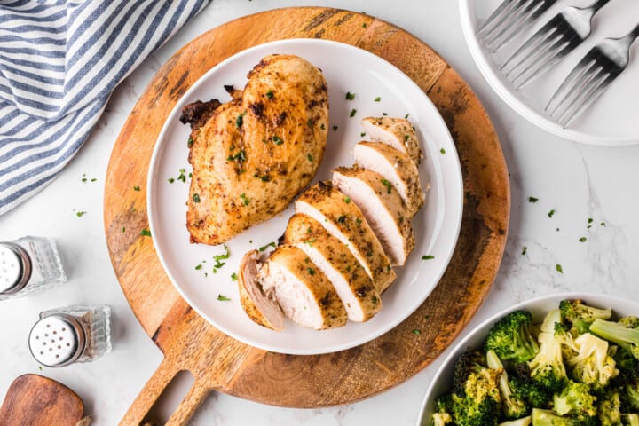 Air Fryer Chicken Breasts on white dinner plates.