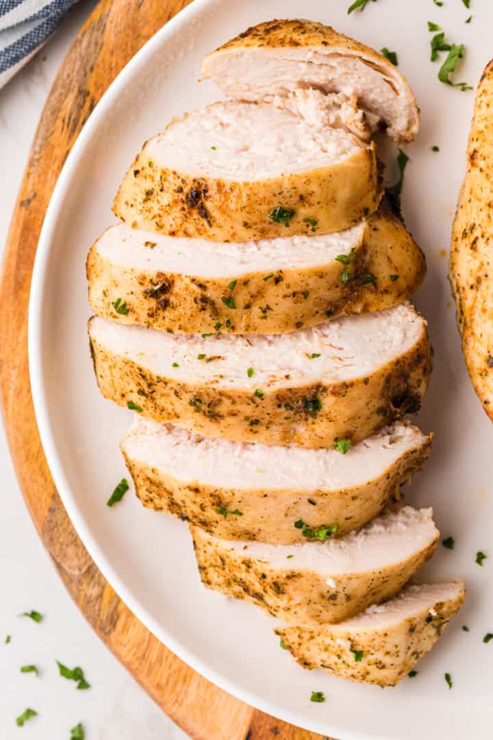 closeup of the chicken breast sliced on white plate.