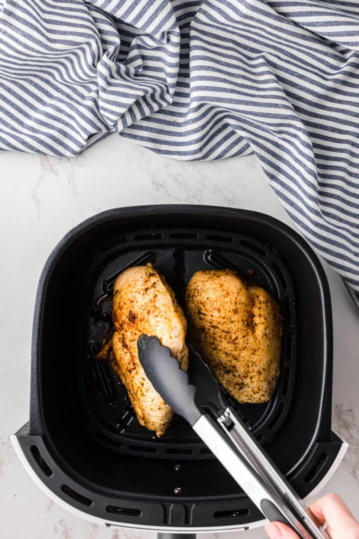 flipping the chicken breasts in the air fryer.