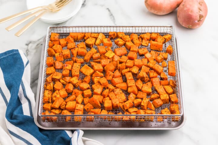 air fryer sweet potatoes in the air fryer basket.