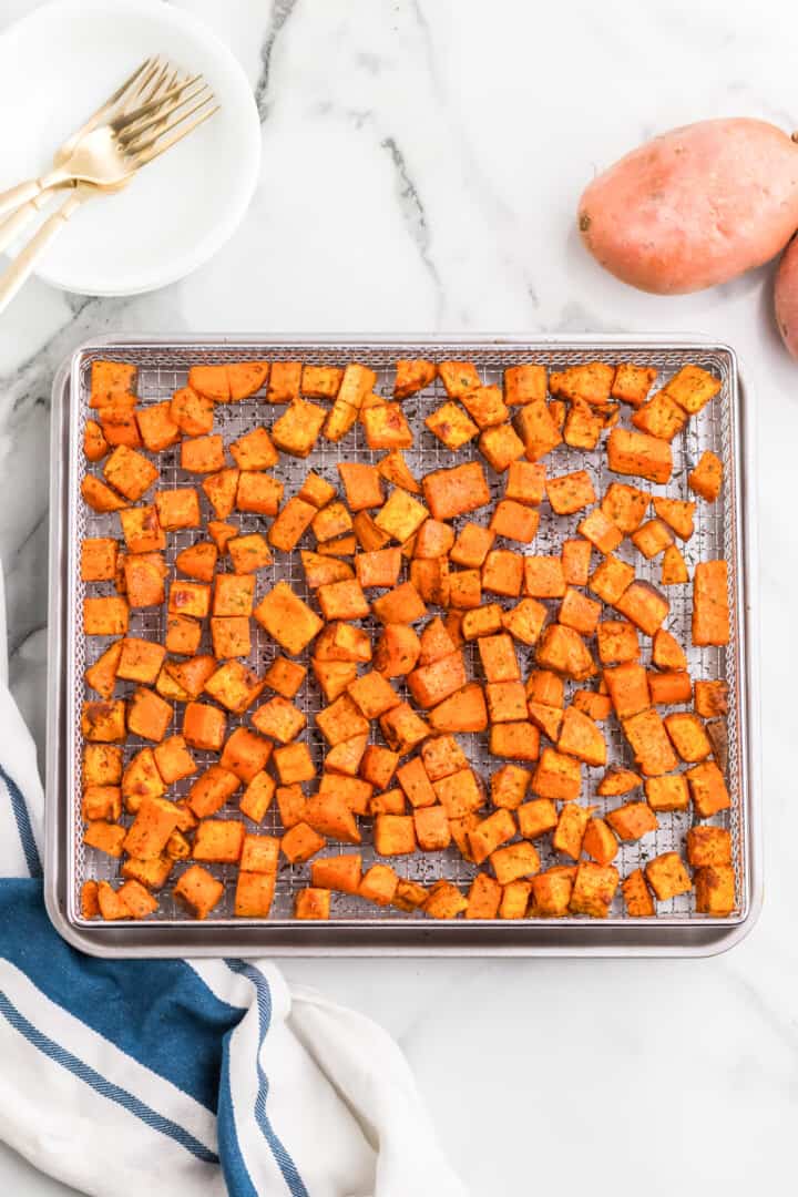 diced and seasoned sweet potatoes on the air fryer rack.