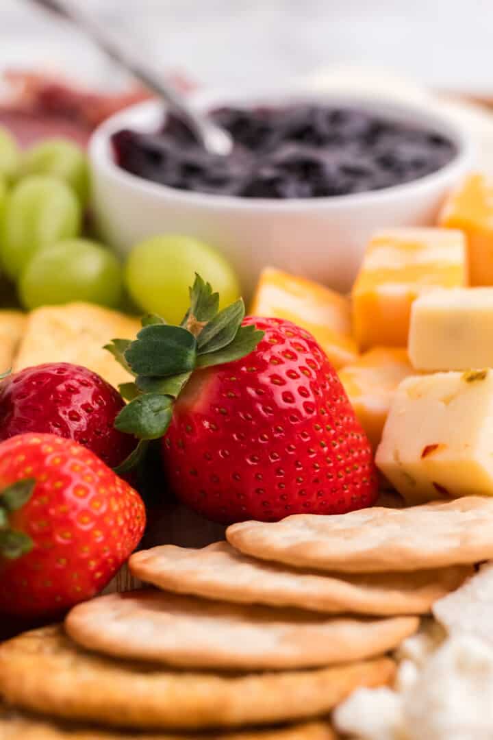 closeup of strawberries on the charcuterie board.