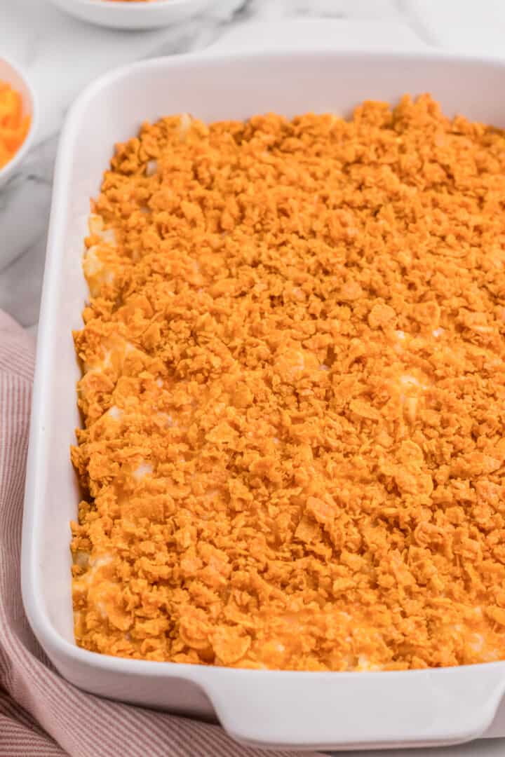 baked Funeral Potatoes in white casserole dish.