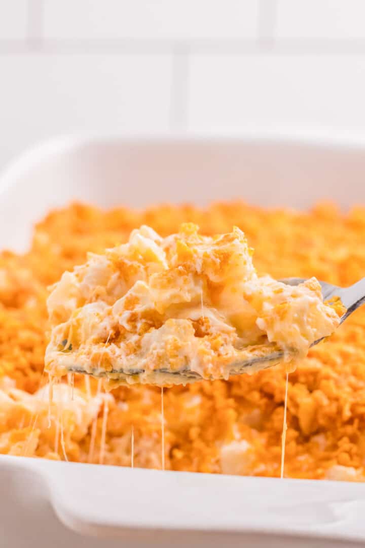 closeup of the funeral potatoes being served on a metal spoon.