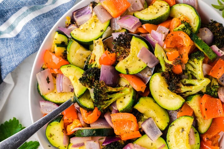 closeup of air fryer vegetables in white serving bowl.