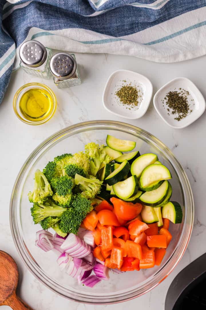 diced vegetables in glass bowl for oil and seasoning.