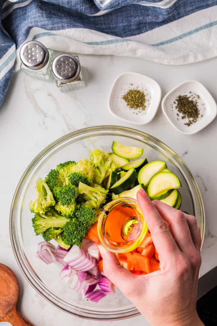 adding oil to the veggies.