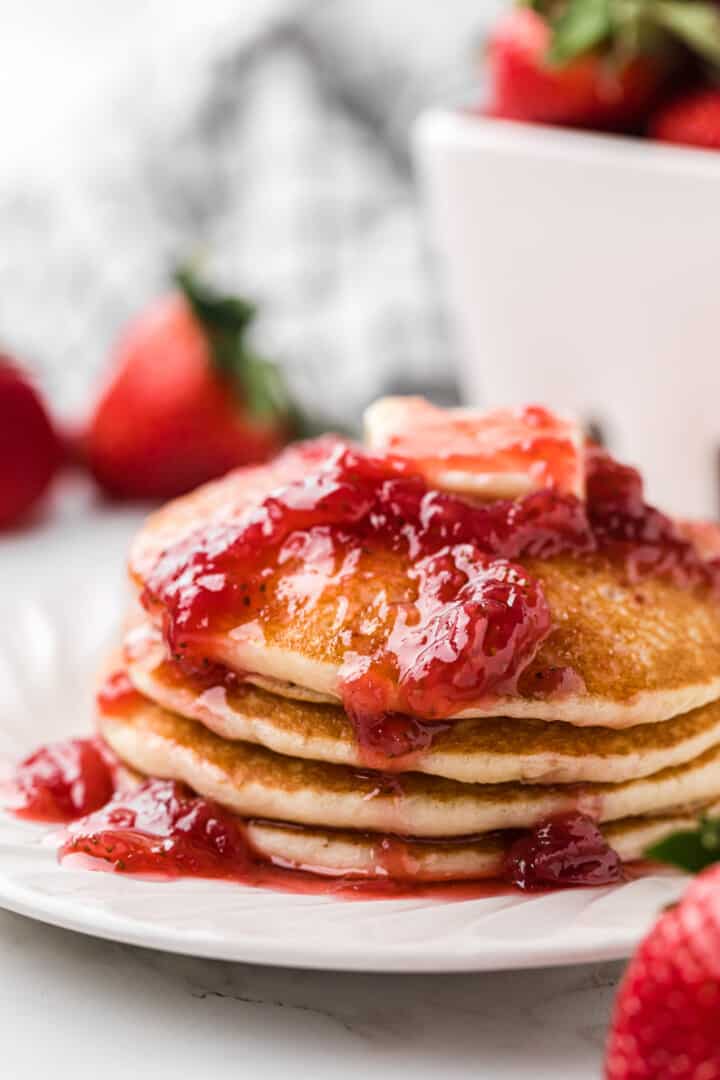 strawberry syrup topped on pancakes.