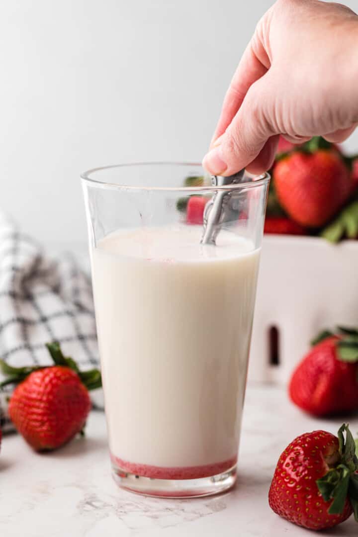 making strawberry milk with the syrup.