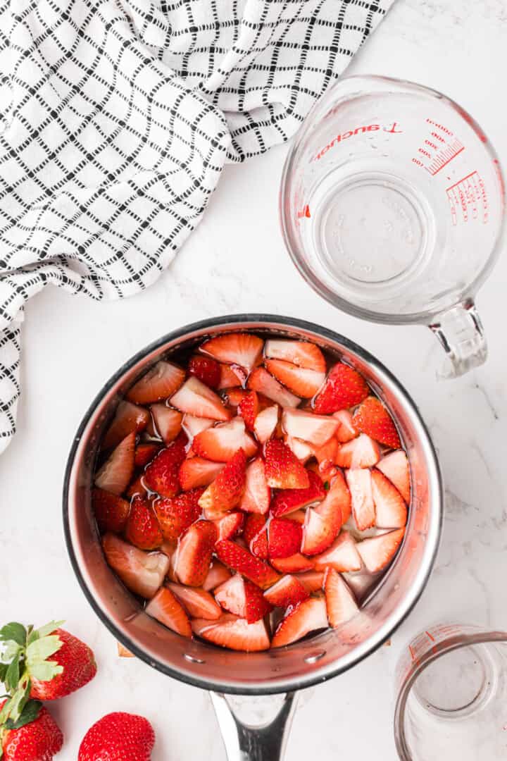 strawberries added to the sauce pan.