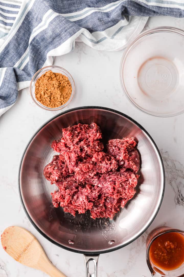 cooking the taco meat in a skillet.