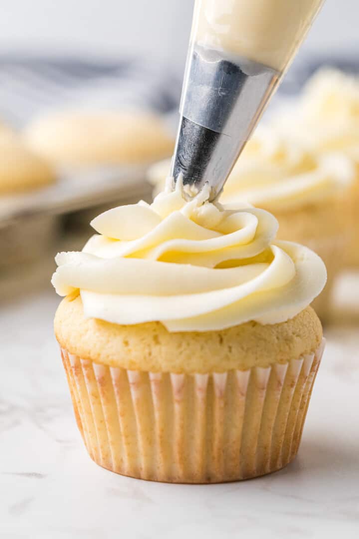 frosting the cupcake.