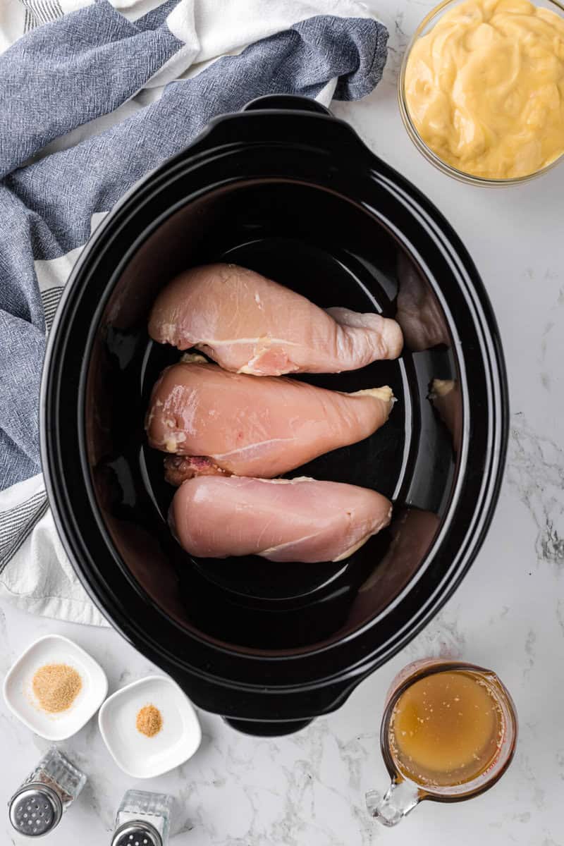 raw chicken breasts in slow cooker.