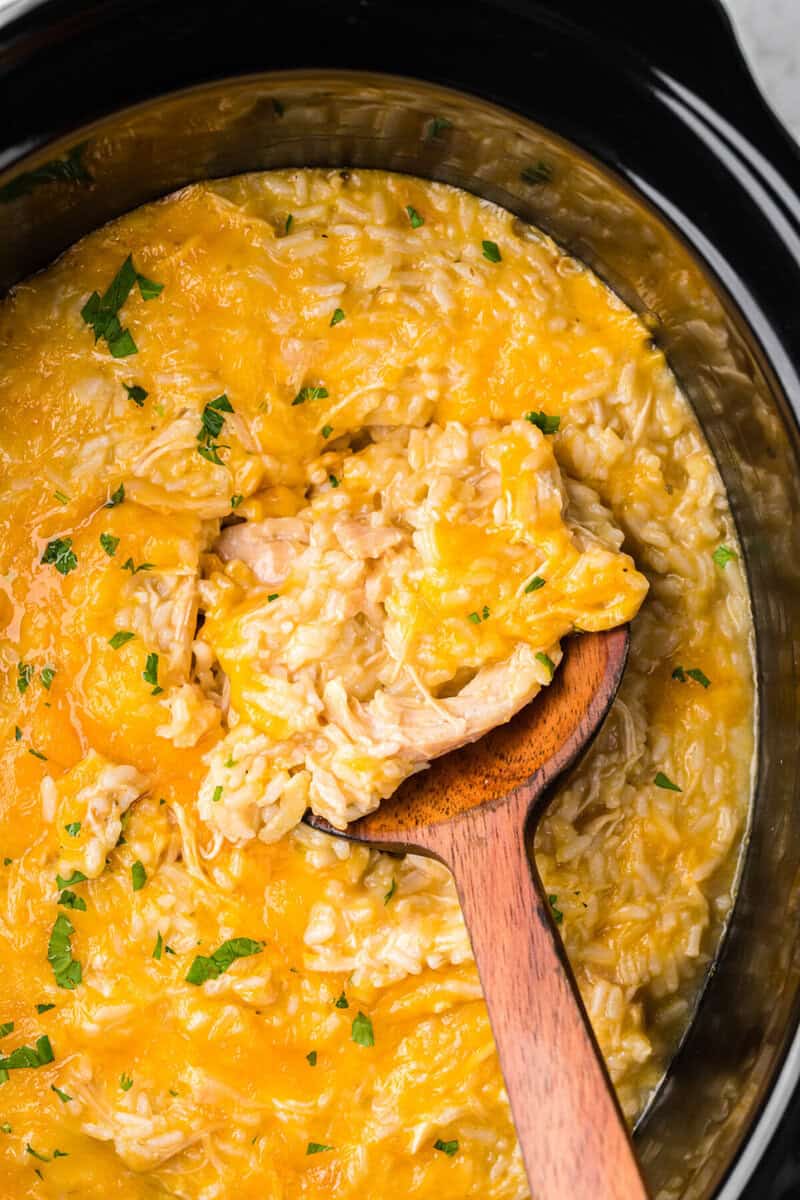 serving the casserole with a wooden ladle.