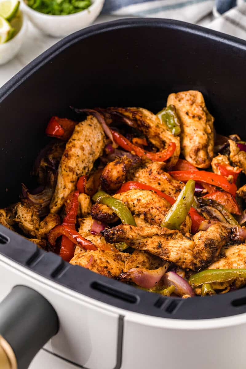 Air Fryer Chicken Fajitas in the air fryer basket cooked.