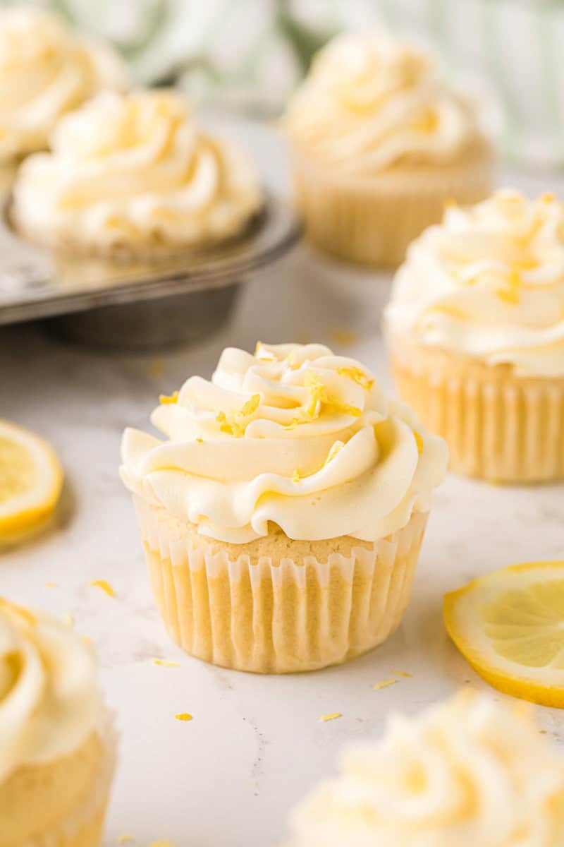 closeup of a Lemon Cupcake frosted and topped with some lemon zest.