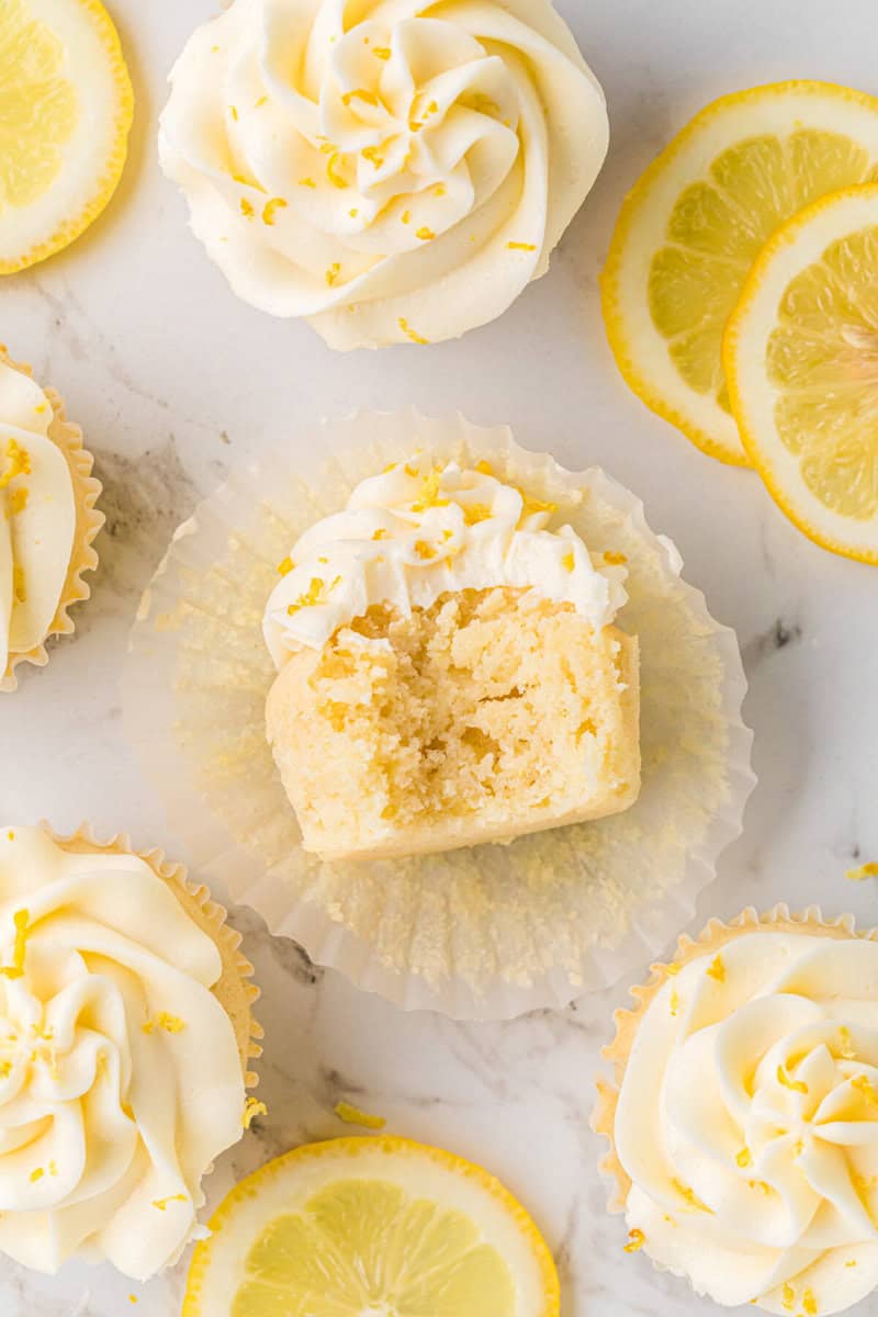 lemon cupcake with a bite taken out of it to show the inside.