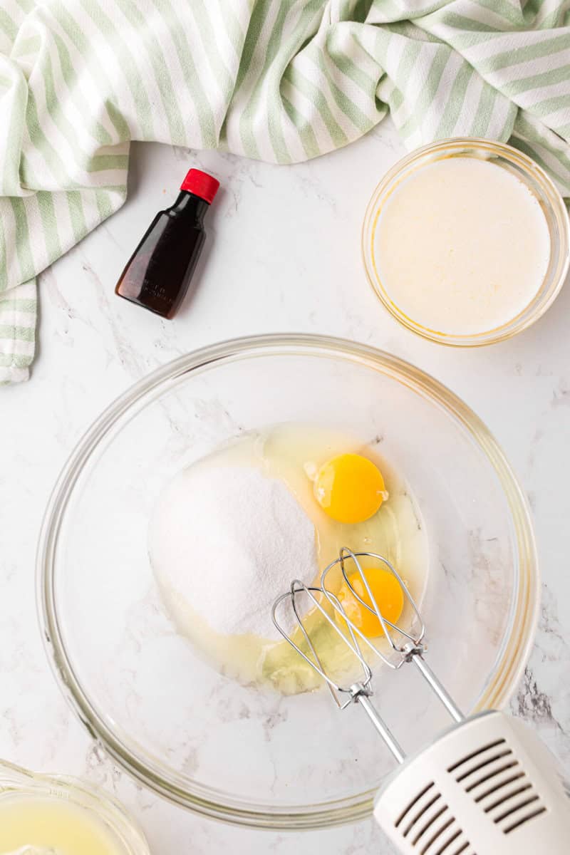 mixing together the sugar and eggs for the cupcakes.